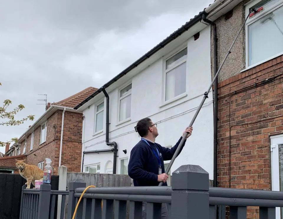 Tom cleaning windows on an Eden job